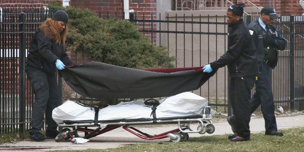 CHICAGO, IL - APRIL 01: Workers remove the body of a 24-year-old man who was shot and killed on South Eberhart Avenue on the city's South Side as Chicago police investigate on April 1, 2013 in Chicago, Illinois. According to published reports, the man was the 73rd homicide victim and the 39th victim under the age of 25 in Chicago in 2013. (Photo by Scott Olson/Getty Images)