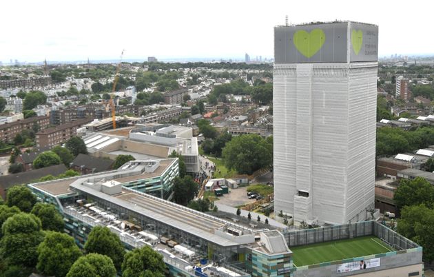 A banner with a green heart wrapped around the Grenfell Tower, one year after the blaze claimed 72 lives