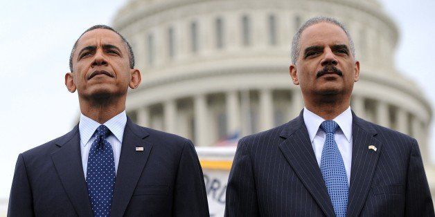 WASHINGTON, DC - MAY 15: (AFP OUT) U.S. President Barack Obama (L) and Attorney General Eric Holder attend the 32nd annual National Peace Officers' Memorial Service at the West Front Lawn at the U.S. Capitol May 15, 2013 in Washington, DC. President Barack Obama delivered remarks at the event, invoking the law enforcement officers who worked to bring the Boston Marathon bombing suspects to justice. (Photo by Olivier Douliery - Pool/Getty Images)