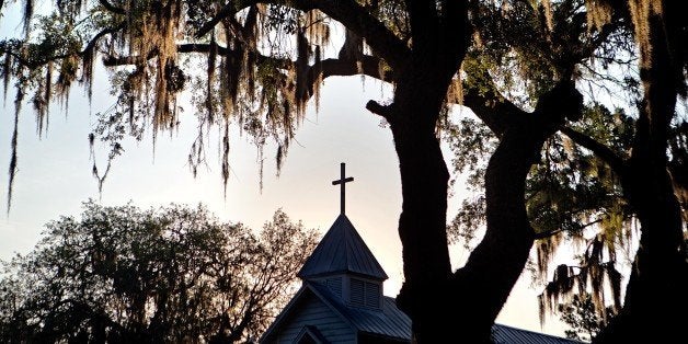 FILE - In this May, 17, 2013 photo, the sun rises behind St. Luke Baptist Church in Hog Hammock, a Geechee community on Sapelo Island, Ga. The commission that oversees the Gullah Geechee Cultural Heritage Corridor running through four states on the Southeast coast is beginning a new phase with a new executive director, new office and new voice in projects such as electric transmission lines that could affect the culture. (AP Photo/David Goldman, File)