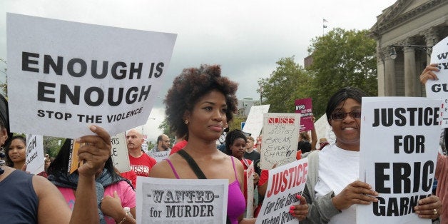 NEW YORK, UNITED STATES - AUGUST 24: People gather to protest the killing of Eric Garner in New York, United States, on August 24, 2014. Garner, 43, died on July 17 as cops tried to cuff him for allegedly selling bootleg cigarettes on a Staten Island sidewalk. (Photo by Selcuk Acar/Anadolu Agency/Getty Images)