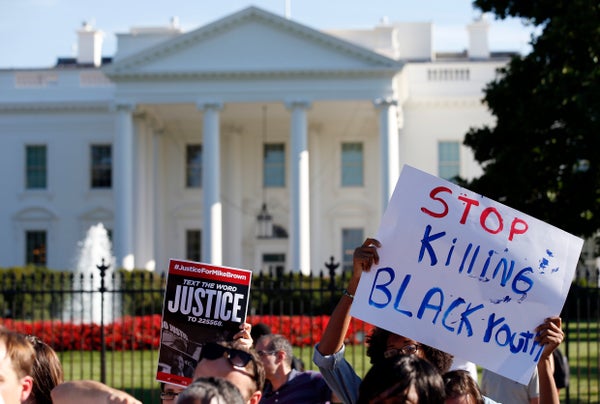 A sign is held during a rally for justice for Michael Brown, and the people of Ferguson, Missouri on Pennsylvania Avenue in f