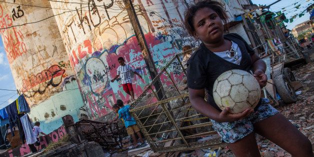 SAO PAULO, BRAZIL - JULY 13: Children play in a football league organized by members of the 'popular committee for World Cup' in Favela do Moinho on July 13, 2014 in Sao Paulo, Brazil. The group protests against corruption and overspending in the construction of stadiums for the World Cup in Brazil (Photo by Victor Moriyama/Getty Images)