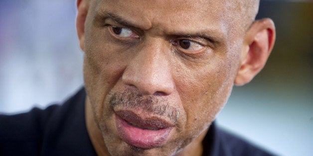 U.S. Cultural Ambassador and former NBA basketball star Kareem Abdul-Jabbar listens to reporters as he visits the Alemao comp
