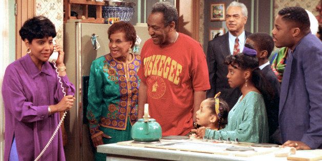 Phylicia Rashad, as Clair Huxtable, talks on the telephone while Bill Cosby, as Dr. Cliff Huxtable and other cast members of the family sitcom "The Cosby Show" gather around during taping of the final episode in New York City, Friday, March 6, 1992. From left clockwise are, Rashad; Clarice Taylor as Anna Huxtable; Cosby; Earl Hyman as Russel Huxtable; unidentified actor, partially hidden; Malcolm Jamal Warner as Theo; Keshia Knight Pulliam as Rudy; and Raven Symone as Olivia. (AP Photo)