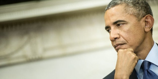 US President Barack Obama listens while Indian Prime Minister Narendra Modi makes a statement to the press after a meeting in the Oval Office of the White House September 30, 2014 in Washington, DC. Obama met with the newly elected Modi during his first trip to the United States as Prime Minister. AFP PHOTO/Brendan SMIALOWSKI (Photo credit should read BRENDAN SMIALOWSKI/AFP/Getty Images)