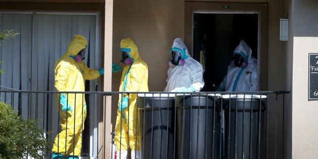 DALLAS, TX - OCTOBER 05: Members of the Cleaning Guys Haz Mat clean up company are seen as they sanitize the apartment where Ebola patient Thomas Eric Duncan was staying before being admitted to a hospital on October 5, 2014 in Dallas, Texas. The first confirmed Ebola virus patient in the United States was staying with family members at The Ivy Apartment complex before being treated at Texas Health Presbyterian Hospital Dallas. State and local officials are working with federal officials to monitor other individuals that had contact with the confirmed patient. (Photo by Joe Raedle/Getty Images)