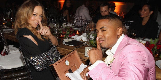 NEW YORK, NY - SEPTEMBER 12: Mariah Carey gives Nas a Louis Vuitton Cigar Humidor as Joel Kinnaman and Olivia Munn look on a
