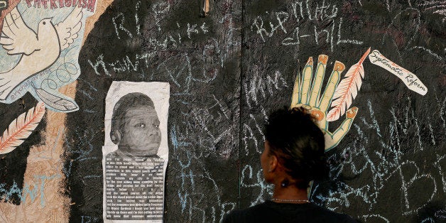 FERGUSON, MO - AUGUST 23: Messages are written on a wall around a picture Michael Brown as peaceful demonstrations continue t