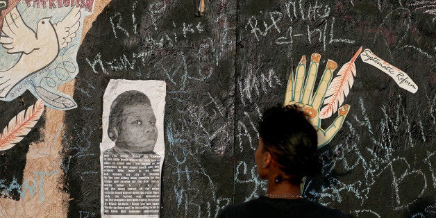 FERGUSON, MO - AUGUST 23: Messages are written on a wall around a picture Michael Brown as peaceful demonstrations continue to protest his shooting death August 23, 2014 in Ferguson, Missouri. Police and protesters have repeatedly clashed over a number of days with demonstrators demanding justice in the shooting death of Michael Brown by a Ferguson police officer on August 9th. (Photo by Joe Raedle/Getty Images)