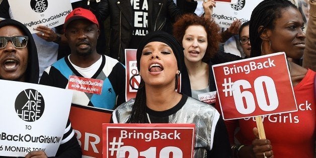 US singer-songwriter Alicia Keys (C) shouts slogans as she joins protesters with the 'Bring Back Our Girls' campaign during a demonstration in front of the Nigerian consulate in New York on October 14, 2014, to mark the six month anniversary of the kidnapping of over 200 Nigerian schoolgirls by Boko Haram militants. Six months since the kidnapping of the teenagers, interest in their plight has waned despite an initial wave of international outrage. AFP PHOTO/Jewel Samad (Photo credit should read JEWEL SAMAD/AFP/Getty Images)