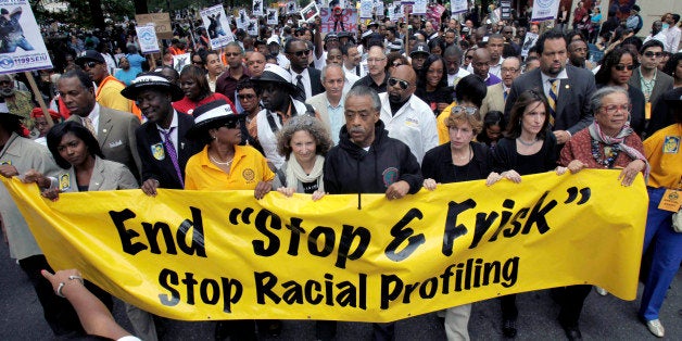 FILE - In this June 17, 2012, file photo, the Rev. Al Sharpton, center, walks with demonstrators during a silent march to end New York's "stop-and-frisk" program. On Aug. 12, 2013, a federal judge sitting in New York said the department made thousands of racially discriminatory street stops and appointed a monitor to direct changes. (AP Photo/Seth Wenig, File)