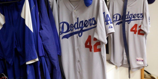 Jerseys with Jackie Robinson's No. 42 hang in the Los Angeles Dodgers' locker room before a baseball game between the Dodgers and the San Francisco Giants on Tuesday, April 15, 2014, in San Francisco. Players from both teams will be wearing the number for Jackie Robinson Day. (AP Photo/Marcio Jose Sanchez)