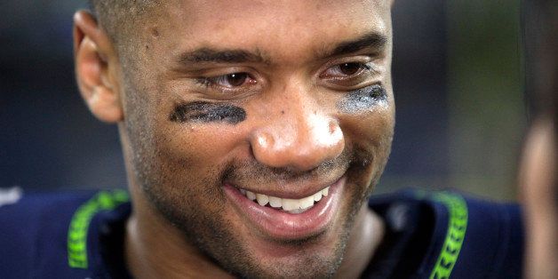 Seattle Seahawks quarterback Russell Wilson smiles after an NFL football game against the Green Bay Packers, Thursday, Sept. 4, 2014, in Seattle. The Seahawks defeated the Packers 36-16. (AP Photo/Elaine Thompson)