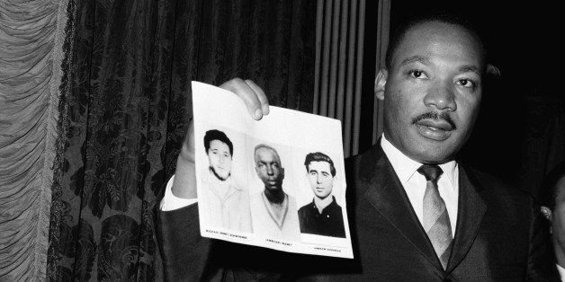 Civil Rights leader Dr. Martin Luther King displays pictures of three civil rights workers at news conference on Dec. 4, 1964 in New York City. The workers were slain in Mississippi last summer. Dr. King commended the FBI for its arrests in Mississippi on Dec. 4 in connection with the slayings. King holds up photos of Andrew Goodman; James Chaney; and Michael Schwerner. The three civil rights workers disappeared in Mississippi near the town of Philadelphia, northeast of Jackson. (AP Photo/ John Lindsay)