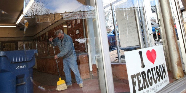 FERGUSON, MO - NOVEMBER 25: A worker cleans up glass at a business that was damaged during a demonstration on November 25, 2014 in Ferguson, Missouri. Demonstrators caused extensive damage in Ferguson and surrounding areas after a St. Louis County grand jury decided to not indict Ferguson police Officer Darren Wilson in the shooting of Michael Brown. (Photo by Justin Sullivan/Getty Images)