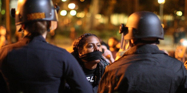 LOS ANGELES, CA - NOVEMBER 25: Protesters and police clash in front of LAPD Headquarters as people react to the grand jury decision not to indict a white police officer who had shot dead an unarmed black teenager in Ferguson, Missouri, in the early morning hours of November 25, 2014 in Los Angeles, California. Police officer Darren Wilson shot 18-year-old Michael Brown on August 9, sparking large ongoing protests. (Photo by David McNew/Getty Images)