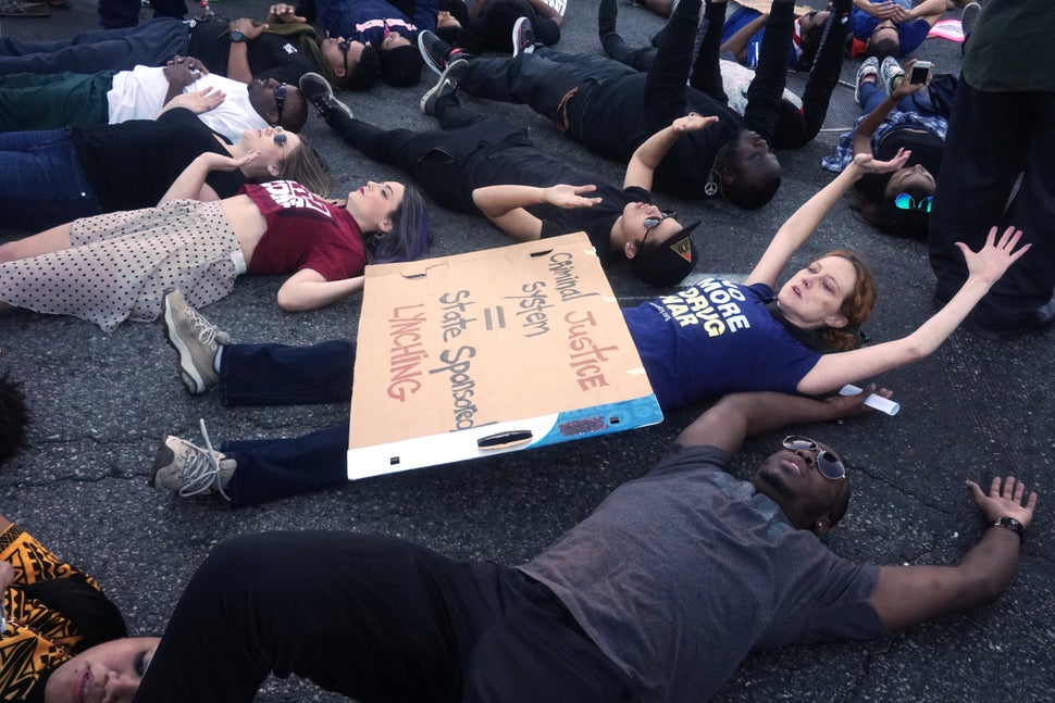Protesters lie down at Martin Luther King Street  in reaction to the grand jury decision not to indict a white police officer