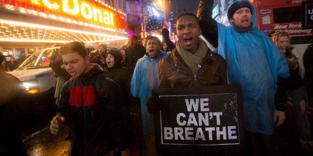 Protesters march against a grand jury's decision not to indict the police officer involved in the death of Eric Garner, Friday, Dec. 5, 2014, in New York. (AP Photo/John Minchillo)