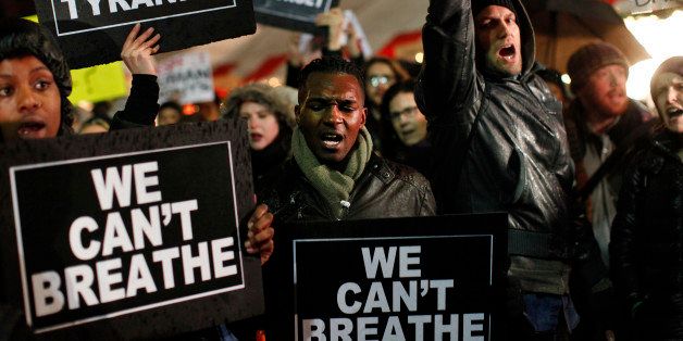 Protesters rallying against a grand jury's decision not to indict the police officer involved in the death of Eric Garner gather in Columbus Circle, Friday, Dec. 5, 2014, in New York. (AP Photo/Jason DeCrow)
