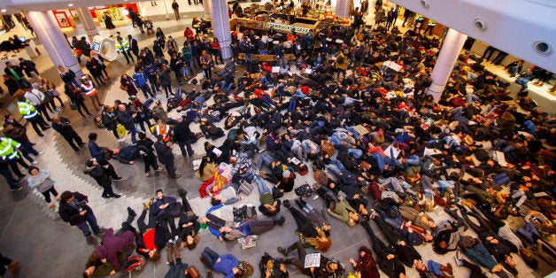 LONDON, UNITED KINGDOM - DECEMBER 10: Protesters stage a 'die-in' as they demonstrate at White City Westfield Shopping Centr