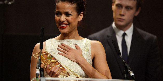 LONDON, ENGLAND - DECEMBER 07: Gugu Mbatha-Raw accepts the award for Best Actress for 'Belle' and George MacKay at the Moet British Independent Film Awards 2014 at Old Billingsgate Market on December 7, 2014 in London, England. (Photo by Dave J Hogan/Getty Images for The Moet British Independent Film Awards)