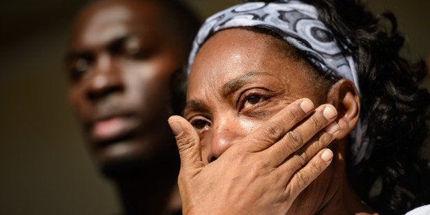 Claudia Lacy wipes away tears during a march to honor the memory of Lennon Lacy and to bring awareness to the case, Saturday, Dec. 13, 2014. Lacy was found hanging from a wooden swing set in a mobile home park near his Bladenboro home in August.