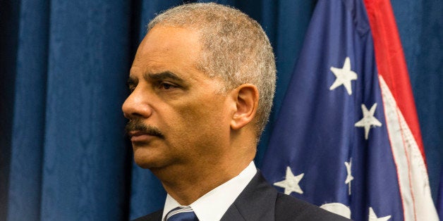 CLEVELAND, OH- DECEMBER 4: U.S. Attorney Eric Holder listens as U.S. Attorney Steve Dettlebach speaks to reporters at a press conference on December 4, 2014 oin Cleveland, Ohio. U.S. Attorney General Eric Holder, Acting Assistant Attorney General Vanita Gupta, and U.S. Attorney Steven Dettelbach spoke at the press conference before hosting a community roundtable discussion as part of the Justice Department's 'Building Community Trust'Â initiative. (Photo by Angelo Merendino/Getty Images)