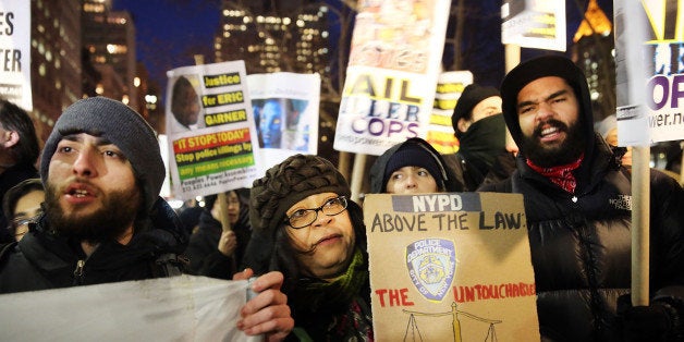 NEW YORK, NY - DECEMBER 19: People demsonstate outside of City Hall against police violence at a rally that was supposed to be in support of the New York Police Department (NYPD) on December 19, 2014 in New York City. Like a number of other cities across the country, New York City continues to experience daily protests as activists, residents and area politicians voice their anger over two grand jury decisions not to indict white police officers in the deaths of two unarmed black men. (Photo by Spencer Platt/Getty Images)