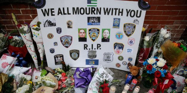 NEW YORK, NY - DECEMBER 22: A view of the memorial for slain NYPD officers, Wenjian Liu and Rafael Ramos, on Tompkins Ave. and Myrtle Ave. where two officers were murdered, in Brooklyn, New York on December 22, 2014. Police officers Rafael Ramos, 40, and Wenjian Liu, 32, were sitting in a marked police car in front of 98 Tompkins Avenue in Bedford-Stuyvesant neighborhood of Brooklyn when the suspect, identified as 28-year-old Ismaaiyl Brinsley, shot them ambush-style, officials said. (Photo by Bilgin Sasmaz/Anadolu Agency/Getty Images)