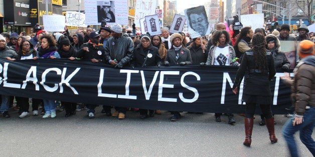 NEW YORK, NY - DECEMBER 13: Thousands of protestors converge on Manhattan's Washington Square Park to march through the Manhattan to protest the police violence on December 13, 2014 in New York, United States. Protestors shout slogans as Hands up, dont shoot, Black lives matter and I cant breathe during the march. (Photo by Mustafa Caglayan/Anadolu Agency/Getty Images)