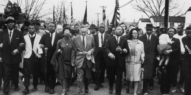 30th March 1965: American civil rights campaigner Martin Luther King (1929 - 1968) and his wife Coretta Scott King lead a black voting rights march from Selma, Alabama, to the state capital in Montgomery. (Photo by William Lovelace/Express/Getty Images)