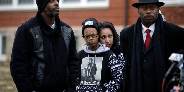 A woman wears a shirt with a photograph of Jerame C. Reid on it, as she listens during a news conference, Wednesday, Jan. 21, 2015, in Bridgeton, N.J. Newly released footage from a police dashboard camera shows police in a Dec. 30, 2014, stop that escalates quickly and leads the fatal shooting of Reid. (AP Photo/Mel Evans)