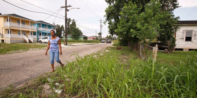 Subrina McCrary walks on Flood Street across the street from her home, a blue double in the background, in the lower ninth ward Wednesday, Oct. 14, 2009 in New Orleans. McCrary believes President Barack Obama can support New Orleans' recovery from Hurricane Katrina by creating more jobs and helping build better schools. What she doesn't want is Obama using her Lower 9th Ward neighborhood as just another photo op. On Thursday, Obama makes his first visit to the city since becoming president, and McCrary's community will be one of the stops. (AP Photo/Judi Bottoni)