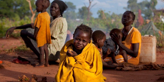 YIDA REFUGEE CAMP, SOUTH SUDAN - JULY 2: Asimara, 3, sits on the ground with her family without shelter after arriving at Yid