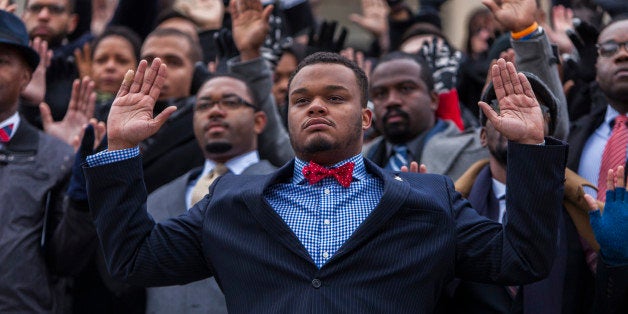 WASHINGTON, D.C - DECEMBER 11 : Congressional staff members raise their hands on the House side of the U.S. Capitol Building in protest after two grand juries decided not to indict the police officers involved in the deaths of Michael Brown and Eric Garner, in Washington, D.C. on December 11, 2014. (Photo by Samuel Corum/Anadolu Agency/Getty Images)