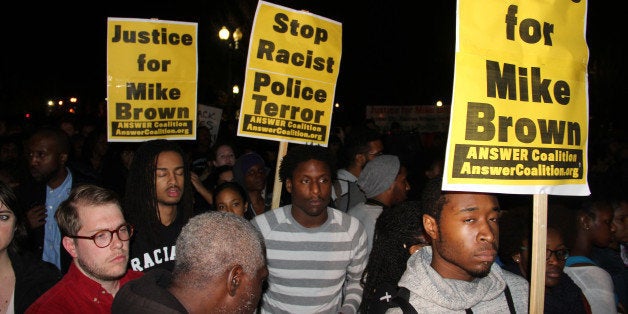 WASHINGTON D.C. - NOVEMBER 24: A group of people gather to protest outside the White House after the grand jury's decision about the police Officer Darren Wilson shot the black teenager Michael Brown dead on November 24, 2014 in Washington, DC. The protestors walked to the U.S. Constitutional Court Headquarter in Washington. According to the jury's decision, Officer Wilson will not face criminal charges for killing Michael Brown. (Photo by Kasm Ileri/Anadolu Agency/Getty Images)