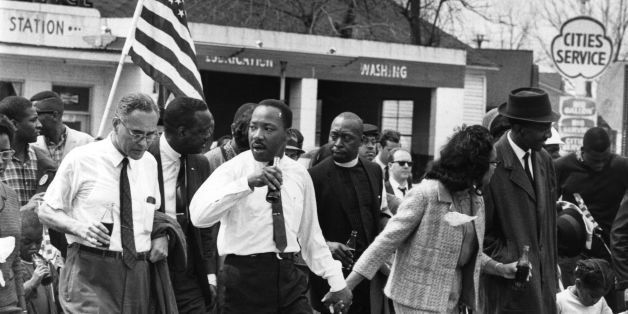 March 1965: Martin Luther King (1929 - 1968) and his wife Coretta Scott King lead a civil rights march from Selma, Alabama, to the state capital in Montgomery. On the left (holding bottle) is American diplomat Ralph Bunche (1904 - 1971). (Photo by William Lovelace/Express/Getty Images)