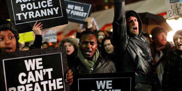 Protesters rallying against a grand jury's decision not to indict the police officer involved in the death of Eric Garner gather in Columbus Circle, Friday, Dec. 5, 2014, in New York. (AP Photo/Jason DeCrow)
