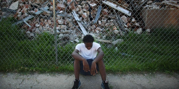 NEW ORLEANS - MAY 27: A teenager sits in front of a demolished section of the B.W. Cooper housing projects May 27, 2008 in New Orleans, Louisiana. B.W. Cooper and the three other major New Orleans housing projects are being torn down to make way for 'mixed-income developments'. The demolition has sparked protests and lawsuits as affordable housing stocks have dwindled and homelessness has doubled following Hurricane Katrina. (Photo by Mario Tama/Getty Images)