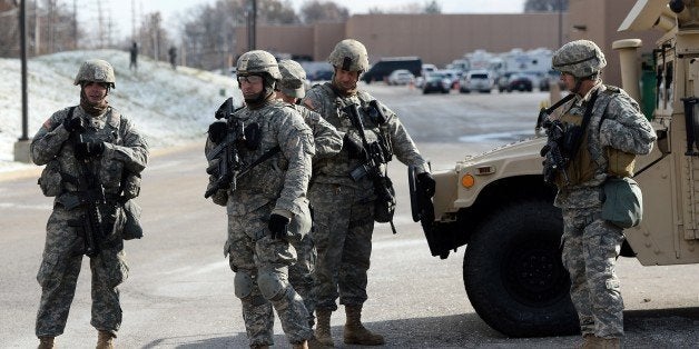 National Guard soldiers secure the police command center set up at a shopping mall in Ferguson, Missouri, on November 27, 2014. Ferguson, a suburb of St Louis, has seen violent protests since the explosive decision by a Missouri grand jury not to charge a police Officer Darren Wilson, who shot dead 18-year-old Michael Brown on August 9. The decision revived long-standing questions about the treatment of young African Americans by police -- questions again asked after the weekend shooting in Cleveland of 12-year-old Tamir Rice. AFP PHOTO/Jewel Samad (Photo credit should read JEWEL SAMAD/AFP/Getty Images)