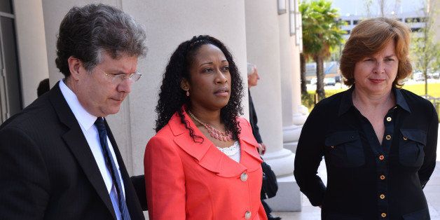 FILE - In a Tuesday, June 10, 2014 file photo, Marissa Alexander is flanked by defense co-counsel Bruce Zimet, left, and Faith Gay, right, stand with as they speak to the media, in Jacksonville, Fla. Alexander, who claimed self-defense after prosecutors say she fired a gun at her estranged husband and his two sons, is expected to be released from prison Tuesday, Jan. 27, 2015, after accepting a plea agreement for time served. (AP Photo/The Florida Times-Union, Bob Mack, Pool)
