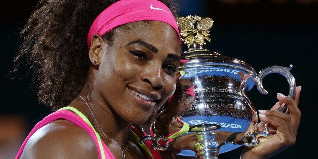 Serena Williams of the U.S. holds the trophy after defeating Maria Sharapova of Russia in the women's singles final at the Australian Open tennis championship in Melbourne, Australia, Saturday, Jan. 31, 2015. (AP Photo/Rob Griffith)