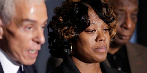 Monica McBride, center, is seen with attorney Gerald Thurswell, left, and spokesman Ron Scott, right, during a news conference in Southfield, Mich., Friday, Nov. 15, 2013. Monica's daughter, Renisha McBride, was shot on Nov. 2 in the face on Theodore P. Wafer's front porch in Dearborn Heights. (AP Photo/Carlos Osorio)