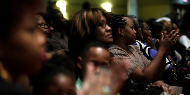 ST. LOUIS MO - NOVEMBER 30 : Worshipers listen as Reverend Al Sharpton speaks about the shooting death of Michael Brown during a church service at Friendly Temple Missionary Baptist Church November 30, 2014 in St. Louis, Missouri. Brown, a 18-year-old black male teenager was fatally wounded by Darren Wilson, a white Ferguson, Missouri Police officer on August 9, 2014. A St. Louis County 12-member grand jury who reviewed evidence related to the shooting decided not to indict Wilson with charges sparking riots through out Ferguson. (Photo by Joshua Lott/Getty Images)