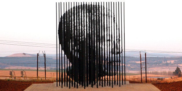 A sculpture of former South African President Nelson Mandela, is presented on August 4, 2012 in Howick, 90 kms South of Durban, commemorating the 50th anniversary of Mandela's capture by the apartheid police. The unique sculpture designed by artist Marco Cianfanelli stands 10 metres tall and is made from 50 steel columns anchored in a concrete base. Mandela, now 94, was arrested as a young liberation fighter on August 5, 1962 near the town of Howick, just months after he founded the armed wing of the African National Congress (ANC). A modest monument at the site of his arrest was put up in 1996, but it will now be eclipsed by the monumental sculpture made up of 50 steel rods of between five and 10 metres high symbolizing the prison. AFP PHOTO / RAJESH JANTILAL (Photo credit should read RAJESH JANTILAL/AFP/Getty Images)