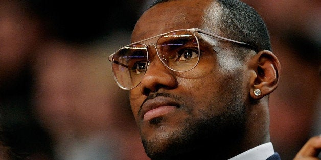 PHOENIX - FEBRUARY 13: LeBron James of the Cleveland Cavaliers sits courtside with his son during the T-Mobile Rookie Challenge & Youth Jam part of 2009 NBA All-Star Weekend at US Airways Center on February 13, 2009 in Phoenix, Arizona. NOTE TO USER: User expressly acknowledges and agrees that, by downloading and or using this photograph, User is consenting to the terms and conditions of the Getty Images License Agreement. (Photo by Kevork Djansezian/Getty Images)