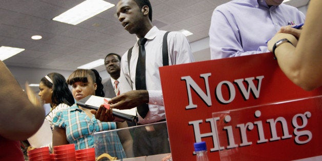 MIAMI, FL - AUGUST 23: Ronald Baker speaks with a job recruiter as he looks for a job at a job fair in the James L. Knight Center on August 23, 2011 in Miami, Florida. The job fair, known as 'For the People' Jobs Initiative, was organized by the Congressional Black Caucus and is part of a nationwide series of job fairs and town hall meetings. (Photo by Joe Raedle/Getty Images)