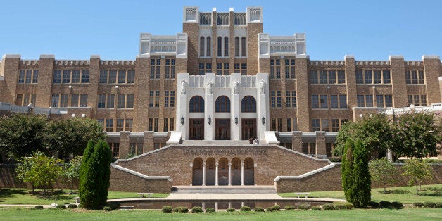 FILE - In the Sept. 10, 2012 file photo, people walk out of Little Rock Central High School in Little Rock, Ark. If an agreement holds, one of the nationâs most historic school desegregation efforts could soon near an end after decades of court battles and $1 billion of aid to Little Rock schools. (AP Photo/Danny Johnston, File)