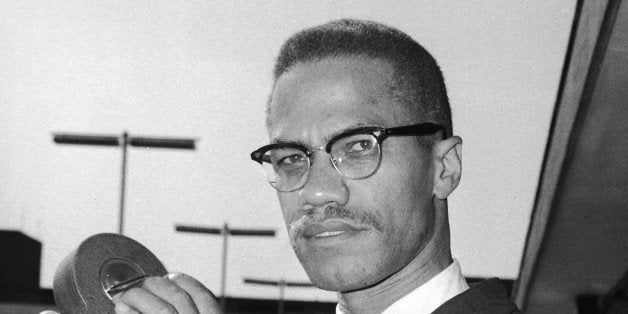 Portrait of American political activist and radical civil rights leader Malcolm X (1925 - 1965) as he holds an 8mm movie came